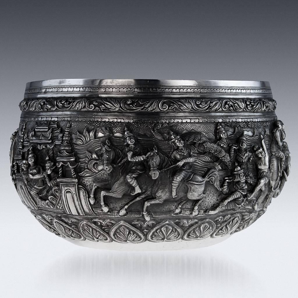 Antique 19th century Burmese, Myanmar solid silver repousse' bowl, large size and particularly heavy gauge, repousse' decorated in high relief with scenes from the Burmese mythology, representing various figures and animals in a landscape, with very