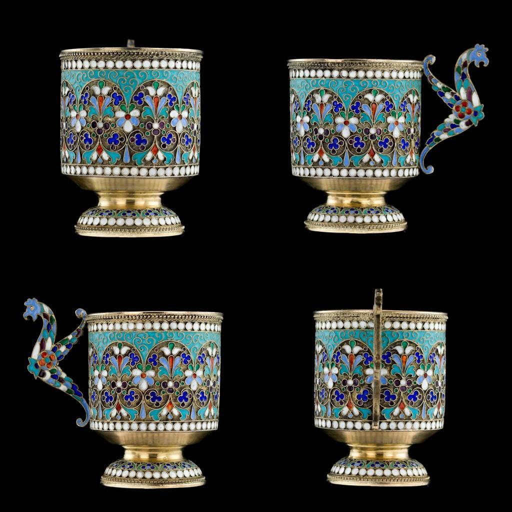 Antique 19th century Imperial Russian solid silver and cloisonne enamel cup, saucer and spoon, each part richly gilt and beautifully enamelled with varicolor flowers, scrolling foliage, stylized cockerel handle and beaded white boarders along the