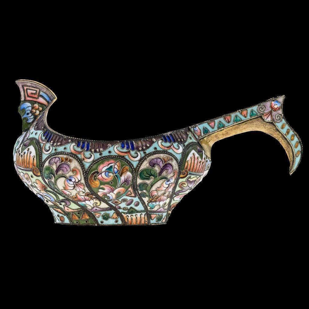 Description:

Antique 20th century imperial Russian solid silver and shaded cloisonne' enamel Kovsh, of traditional oval form, with raised prow and hook handle, the body with lobed cartouches beautifully decorated with various shaded polychrome
