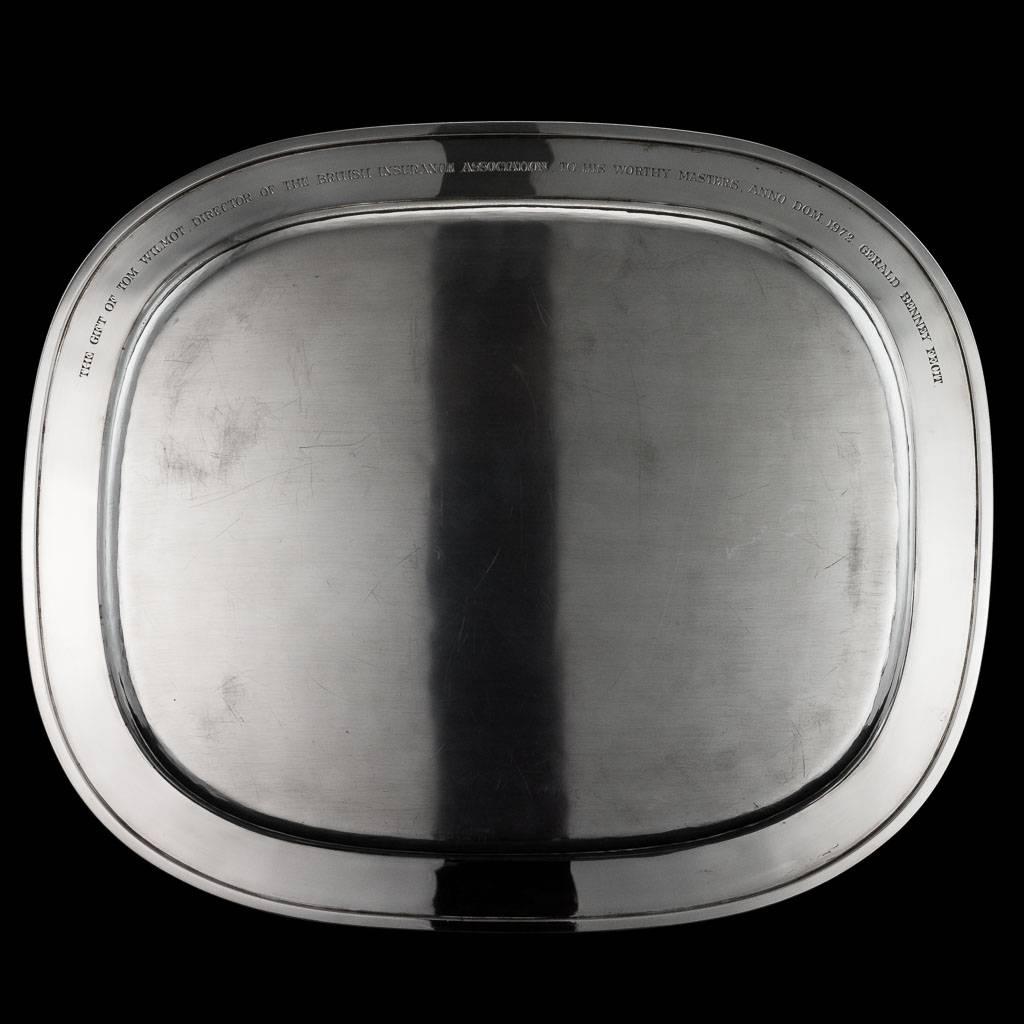 
Description

20th century solid silver tray, oblong form, the rim decorated with raised bark effect textured surface, the center bearing an engraved crest 'safe guard' and a crest of a castle to the top. Underneath engraved 'The gift of Tom