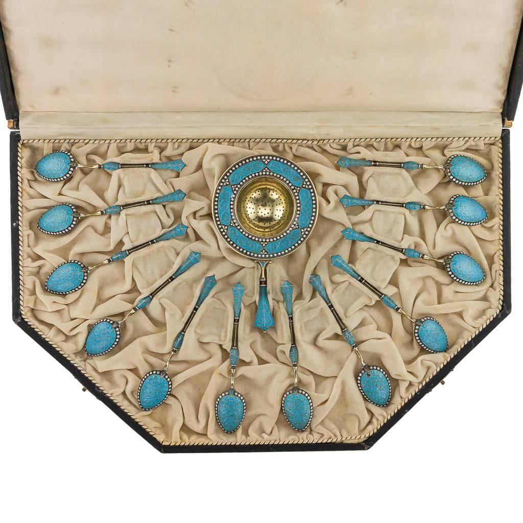 Antique 19th century Norwegian solid silver and cloisonne' enamel set of 12 tea spoons and tea strainer, the silver is richly gilt, decorated with blue turquoise enamel on wirework scrolls, with white beaded boarder on matted silver ground.

Each