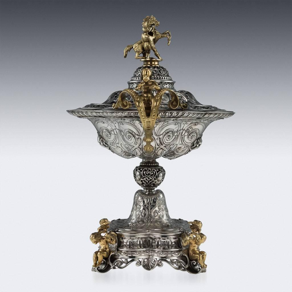 Antique 19th century unique and exceptionally rare French solid silver figural vase and cover, of quatrefoil form, the base and handles mounted with cast cherubs and the surfaces richly chased with masks, arabesques and other motifs, equestrian