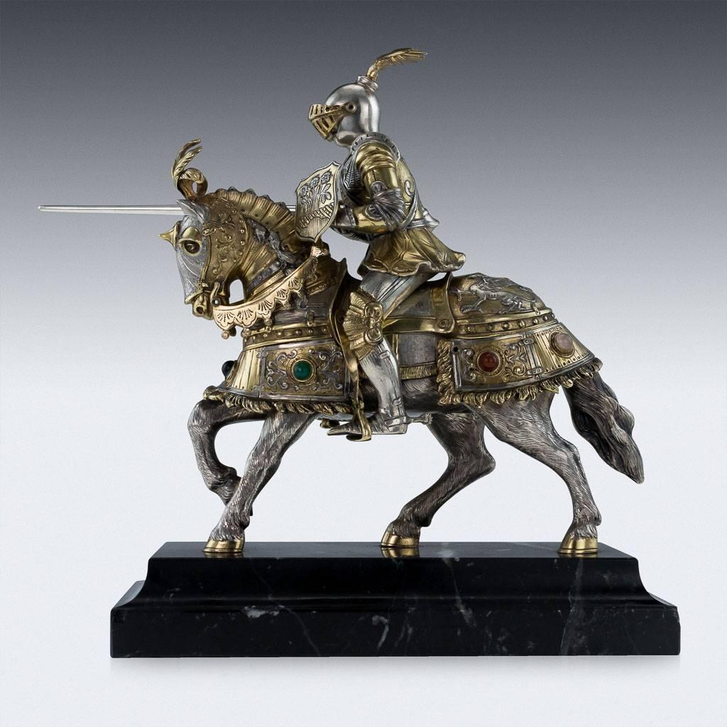 Antique early-20th century German solid silver figure, modeled as a jousting knight on horseback, holding detachable spear and shield, impressively large and very naturalistically well-refined, horse and rider clad in armor with movable helmet