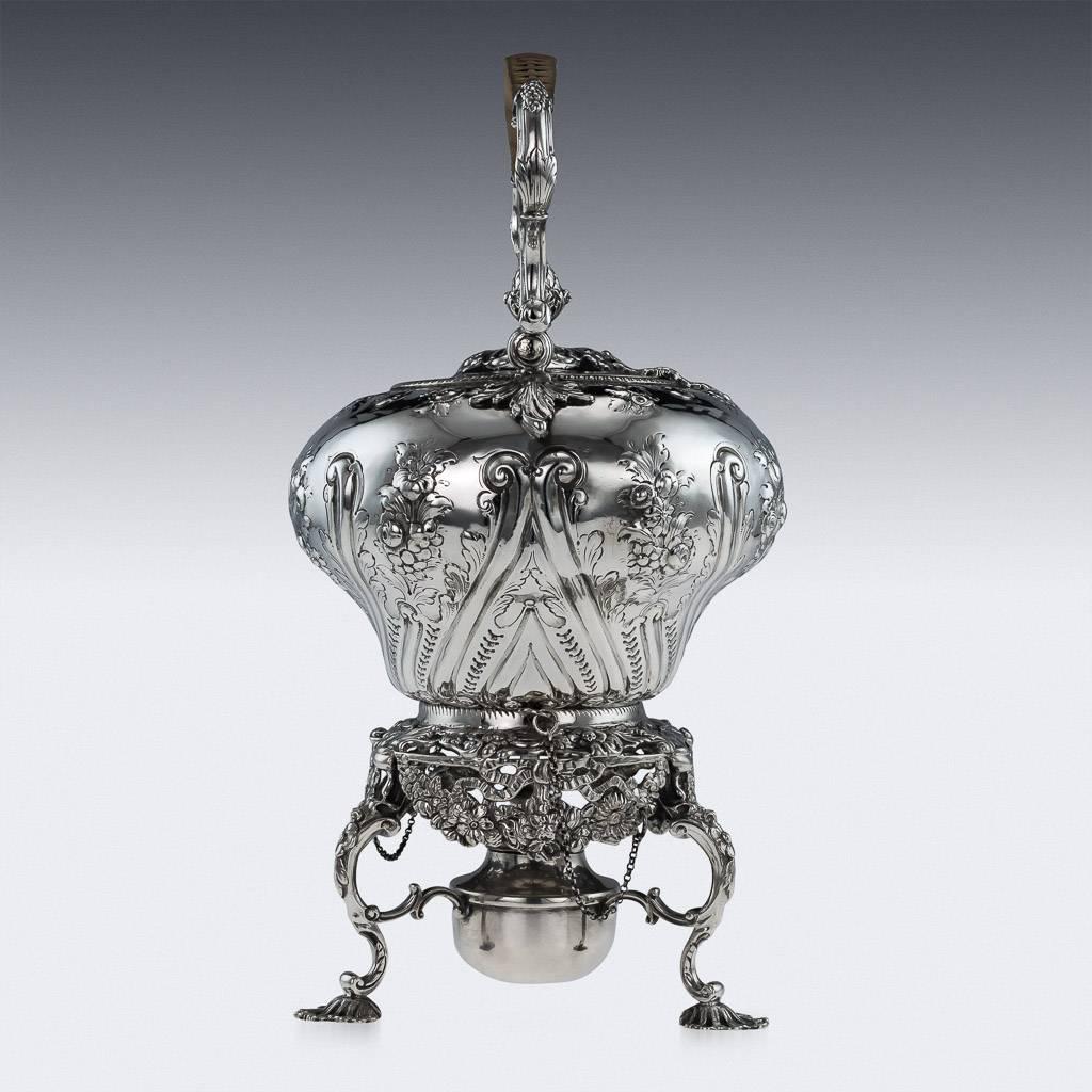 Description:

Antique 18th century Georgian solid silver tea kettle on a three feet spirit burner stand. The inverted pear-shaped pot is profusely embossed with a very detailed floral and scroll decoration, with a wicker bound swinging scroll