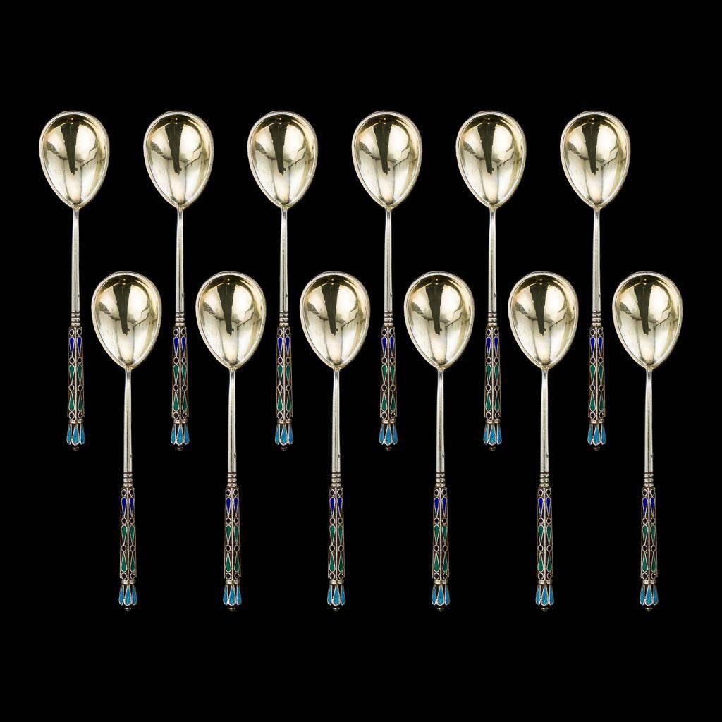 Antique 19th century rare Imperial Russian solid silver set of 12 tea spoons, each richly gilt, beautifully cloisonne' enamelled with a multicolored scrolling foliage and floral decoration on a white ground surrounded by blue beads.

Each piece is
