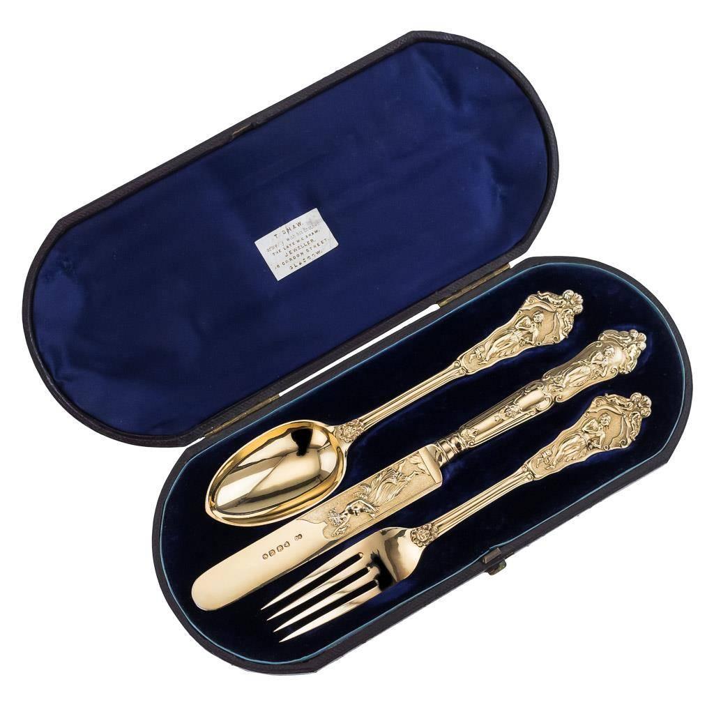 Antique 19th century rare Victorian solid silver christening set, comprising a fork, a knife and a spoon, each richly gilt and beautifully cast and chased in the 