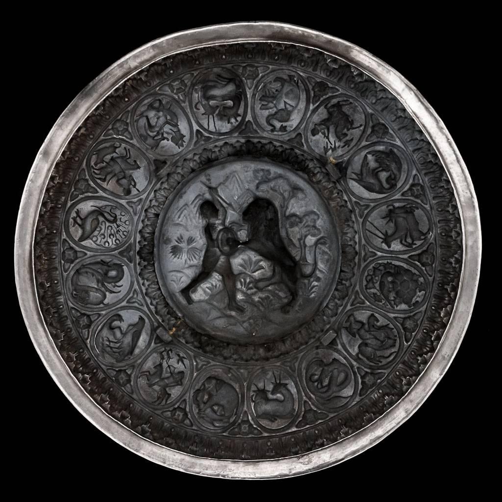 Antique 19th century Indian solid silver large presentation plaque in the form of a Indo-Persian Dhal (shield), unique and exceptionally decorative, of domed circular form, repousse' decorated in very high relief, the central roundel depicting a man