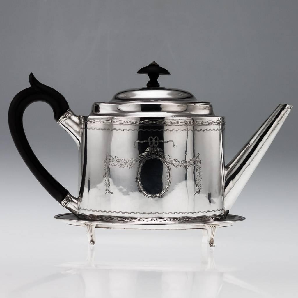 Antique 18th century Georgian exceptionally rare solid silver teapot on stand, both parts of oval form, the teapot and the stand are engraved with bright-cut garlands, ebonized handle and finial, the base bearing the initial 