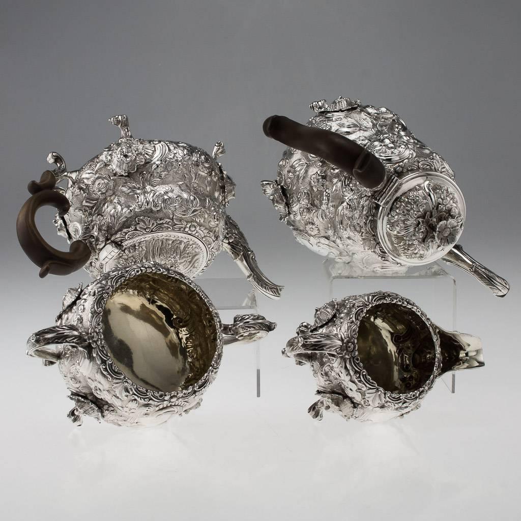 Antique 19th century magnificent George III solid silver tea and coffee set, comprising a coffee pot, teapot, sugar bowl and cream jug, each piece exceptionally heavy, crisp and decorative, chased with flowers and Rococo scrolls, cast mask and