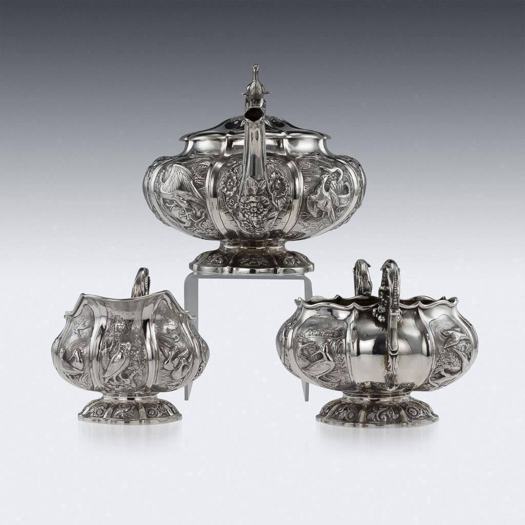 Antique 19th century Regency solid silver three-piece tea set, consisting of a teapot, sugar bowl and cream jug, each lobed body resting on flat shaped spreading domed foot, the body chased and embossed with game birds in landscape, leaf-capped