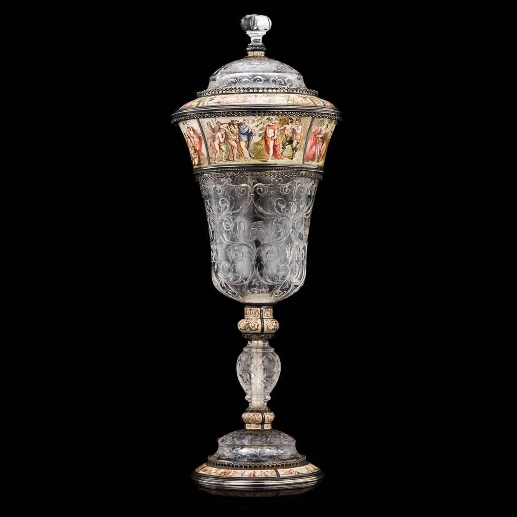Description

Antique 19th century Austrian rock crystal and enamelled solid silver-gilt standing cup and cover, the rock crystal tapering body, foot and domed cover profusely carved with scrolling foliage in the Renaissance style, the silver