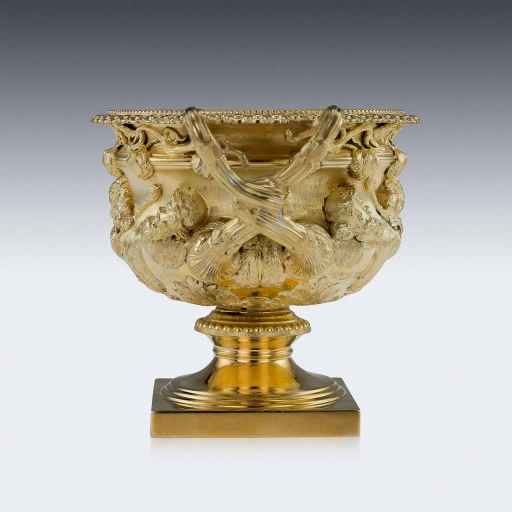 Antique 20th century Edwardian exceptionally rare solid silver gilt Warwick vase, of typical form on square base, with pedestal stem and acanthus at base of bowl, the sides applied with classical heads and lions pelts, with two entwining vine