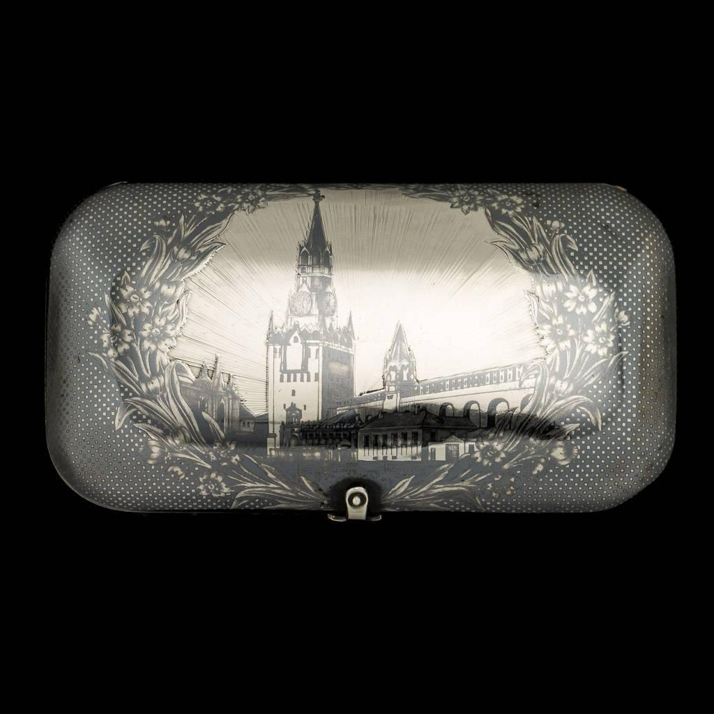 Description

Antique 19th century Imperial Russian solid silver & niello enamel large cigarette case, parcel gilt, each side decorated with a niello enamel decoration, the cover depicting view of the Kremlin surrounded by flowers, reverse with a