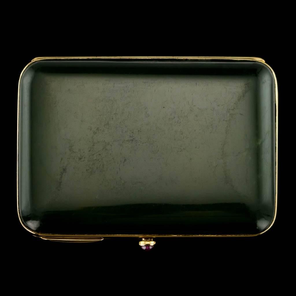 Antique early 20th century Russian style 18 carat gold mounted nephrite cigarette case, rectangular shaped with rounded corners, mounted with 18k gold frame and a ruby cabutchon thumb-piece. Not hallmarked (acid tested 750 gold standard), retailed