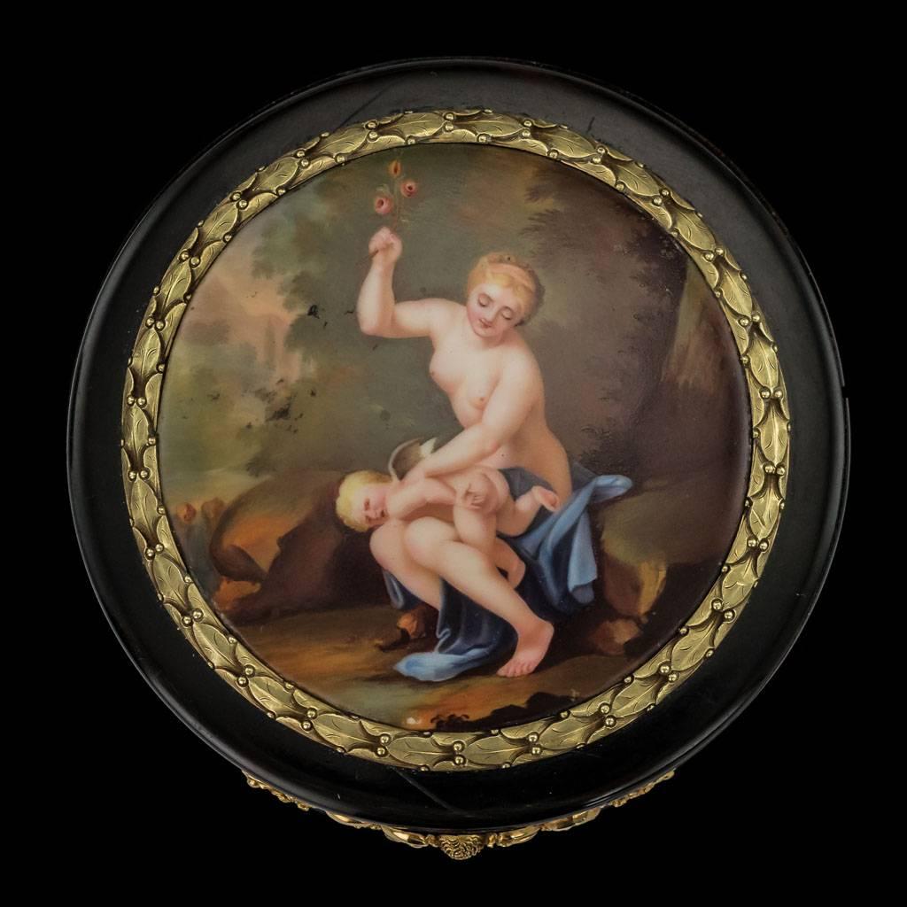 Antique early 19th century French large 18-karat gold-mounted, hand painted enamel miniature snuff box, round shaped and slightly concave for easy access, with a stylized floral boarder and elaborate thumbpiece, the top applied with a gold mounted