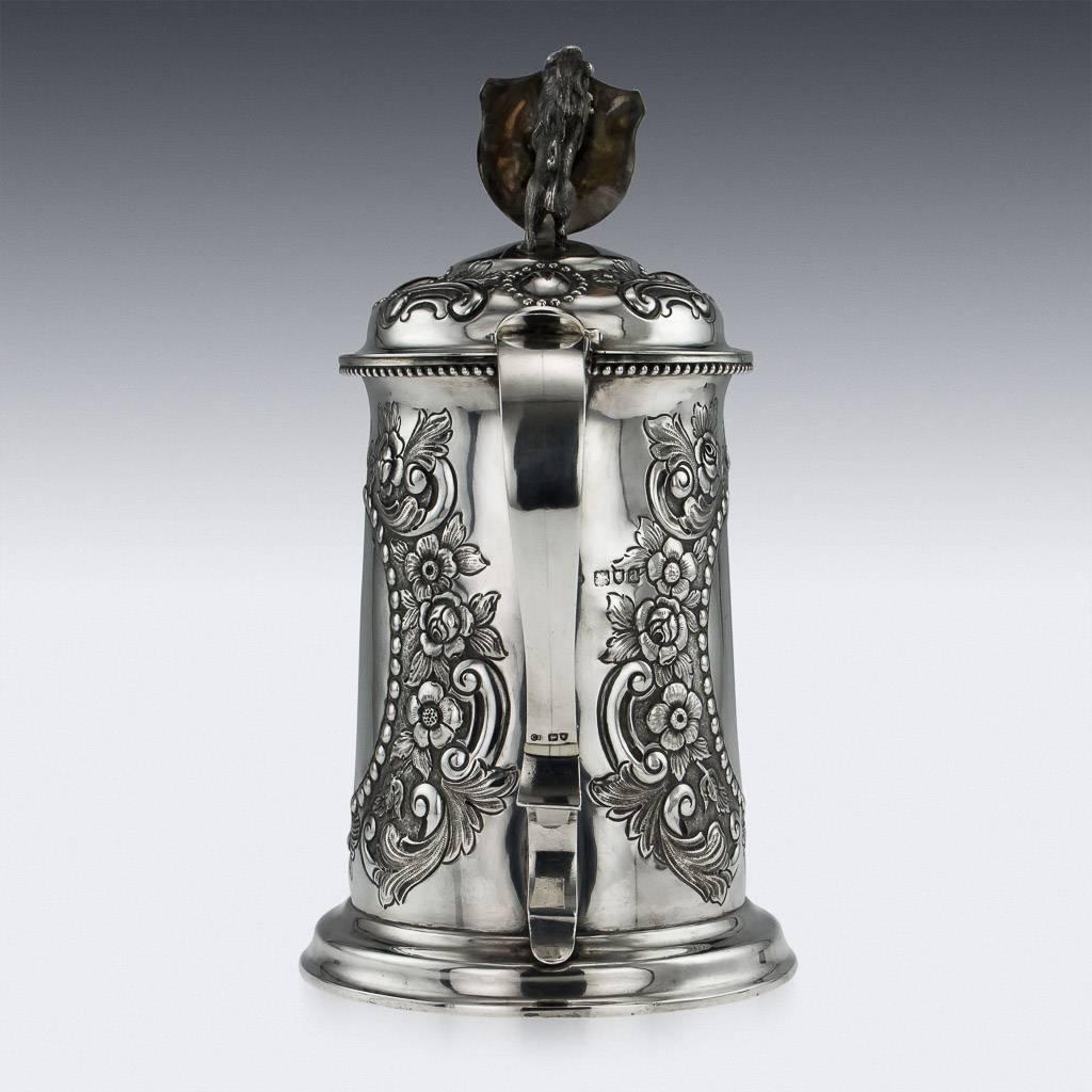 Description

Antique 19th century Victorian solid silver large and decorative presentation lidded flagon, of tapering cylindrical form on a spreading foot, richly parcel-gilt, mounted with a large scroll handle, the sides are profusely embossed