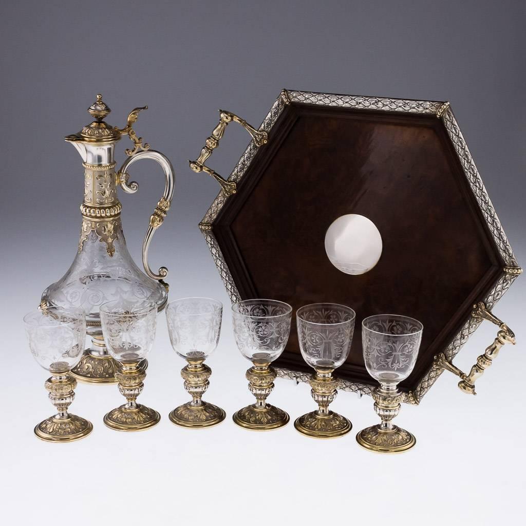 Description
Antique 19th century German solid silver mounted large and exceptional drinking set on a tray, comprising of a large claret jug, six goblets and an exceptional burr walnut hexagonal tray.

Each piece is fitted with parcel gilt solid