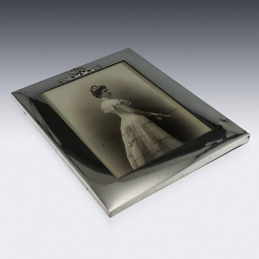 Antique 20th century Italian Royal provenance solid silver photograph frame, particularly large, the top applied with a crown, mounted on a wood and fabric bound back with easel support and glass to protect the photo. The photograph is dipicting