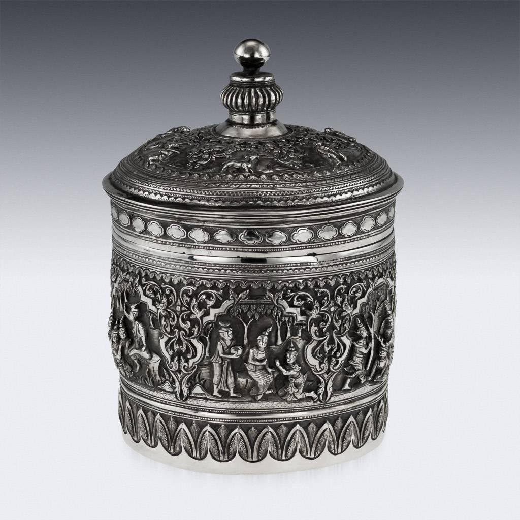 Antique early 20th century Burmese solid silver betel box, highly-decorative, repousse' decorated in high relief depicting different traditional scenes from the Burmese mythology, showing very detailed figures set against a chiselled matted