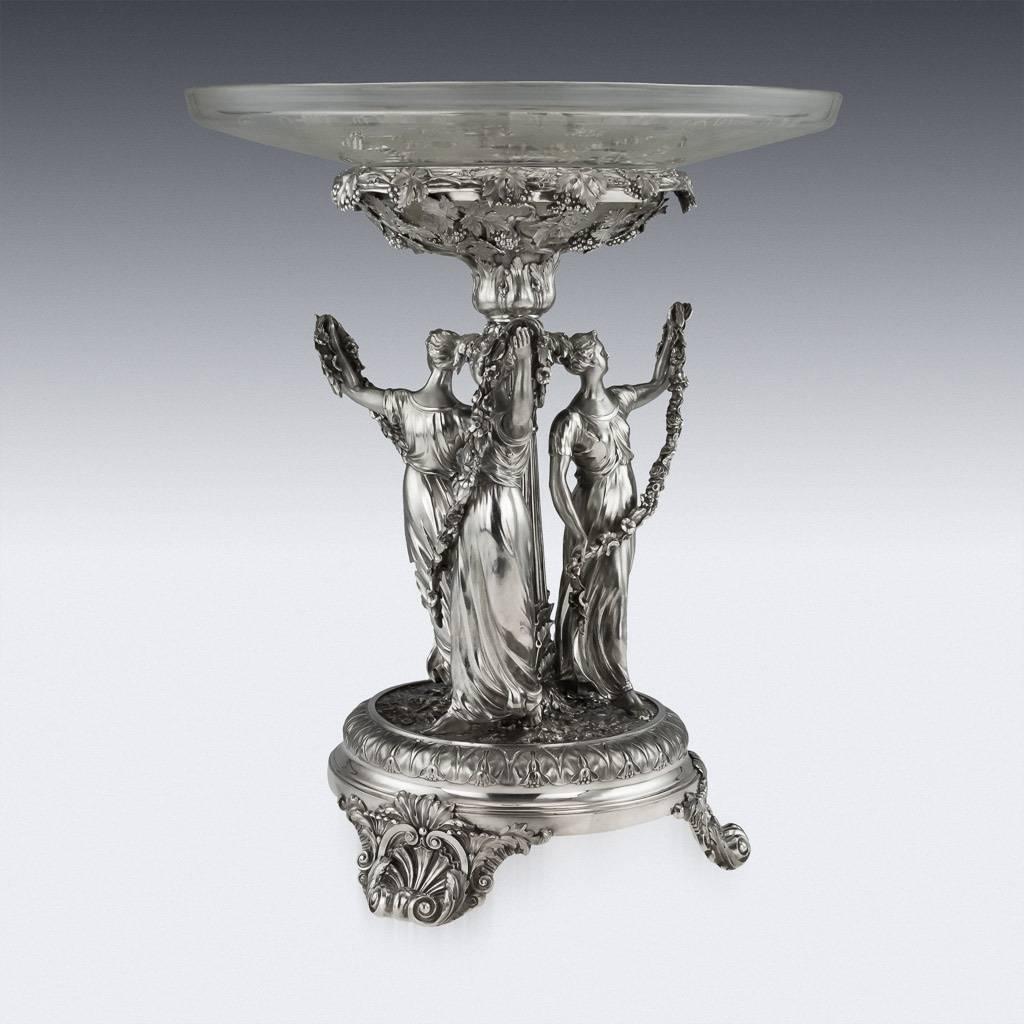 DESCRIPTION
Antique early-19th Century Georgian Monumental solid silver figural centerpiece, raised on three cast scroll and shell feet, the base is applied with a very crisp scrolling foliate decoration in relief, supporting three large and finely