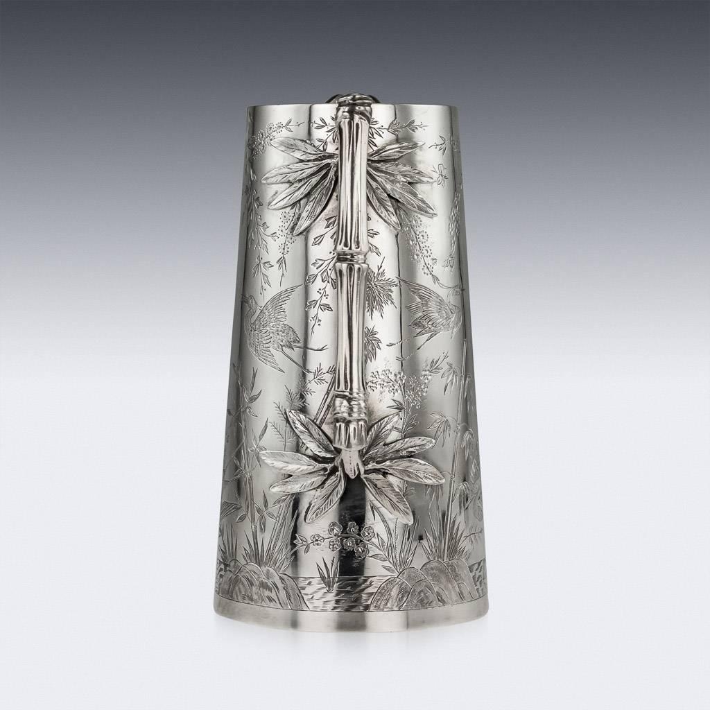 DESCRIPTION
Antique late-19th Century Chinese exceptional solid silver water jug, the straight body beautifully hand engraved with cranes surrounded by bamboo trees in landscape, mounted spout intricately engraved with foliage, the realistically