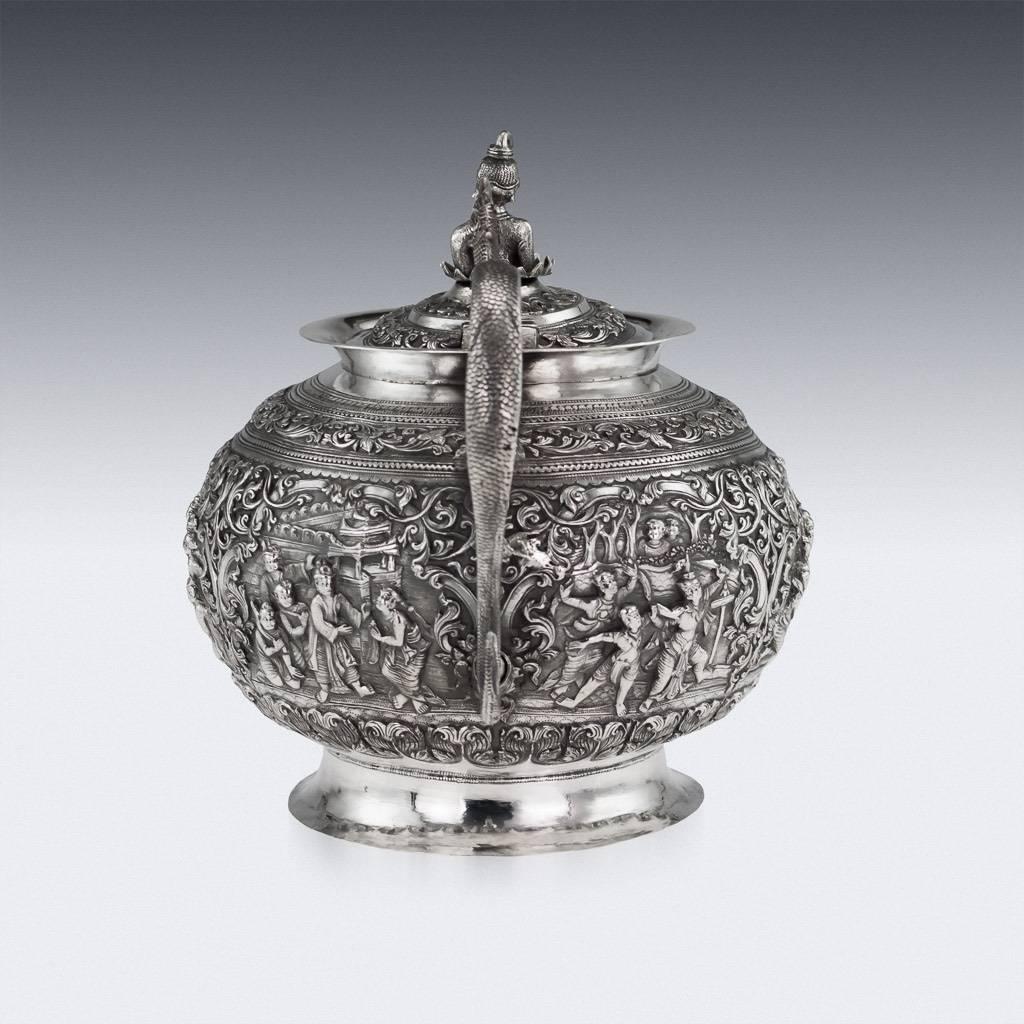 Antique early-20th century magnificent Burmese, Myanmar solid silver teapot, particularly large and highly-decorative, chased and repoussed with various scenes from Burmese mythology on finely tooled ground. Applied with a cast figural naga handle