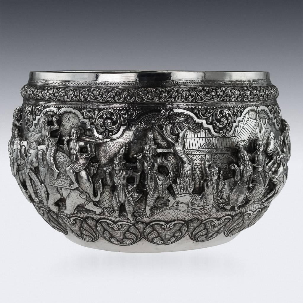 DESCRIPTION
Antique early-20th Century Monumental Burmese, Myanmar Solid Silver Thabeik bowl, extremely large and heavy gauge, repousse' decorated in high relief depicting different traditional scenes from the Burmese mythology, showing detailed
