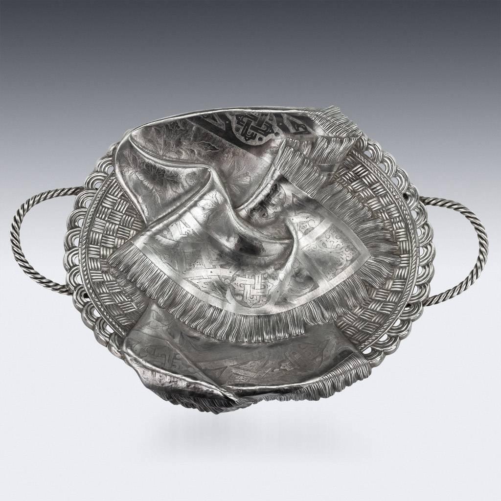 Antique early 20th century Russian solid silver trompe l'oeil bread basket, of oval basket weave form, embellished with a fringed cloth, flanked by a pair of ropetwist handles and raised on wirework feet. Hallmarked Russian silver 84 (875 standard),