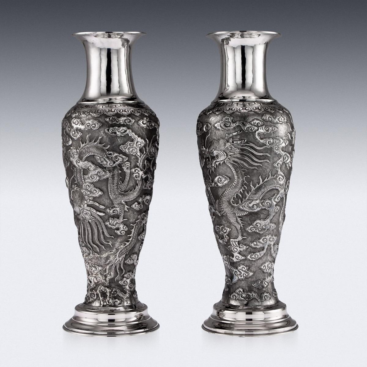 Antique 19th century rare Chinese export solid silver pair of large vases, impressive and exceptionally fine, decorated with repoussé flying dragons amongst clouds on a matted ground, the centre of the vase bearing the Chinese symbol of longevity,