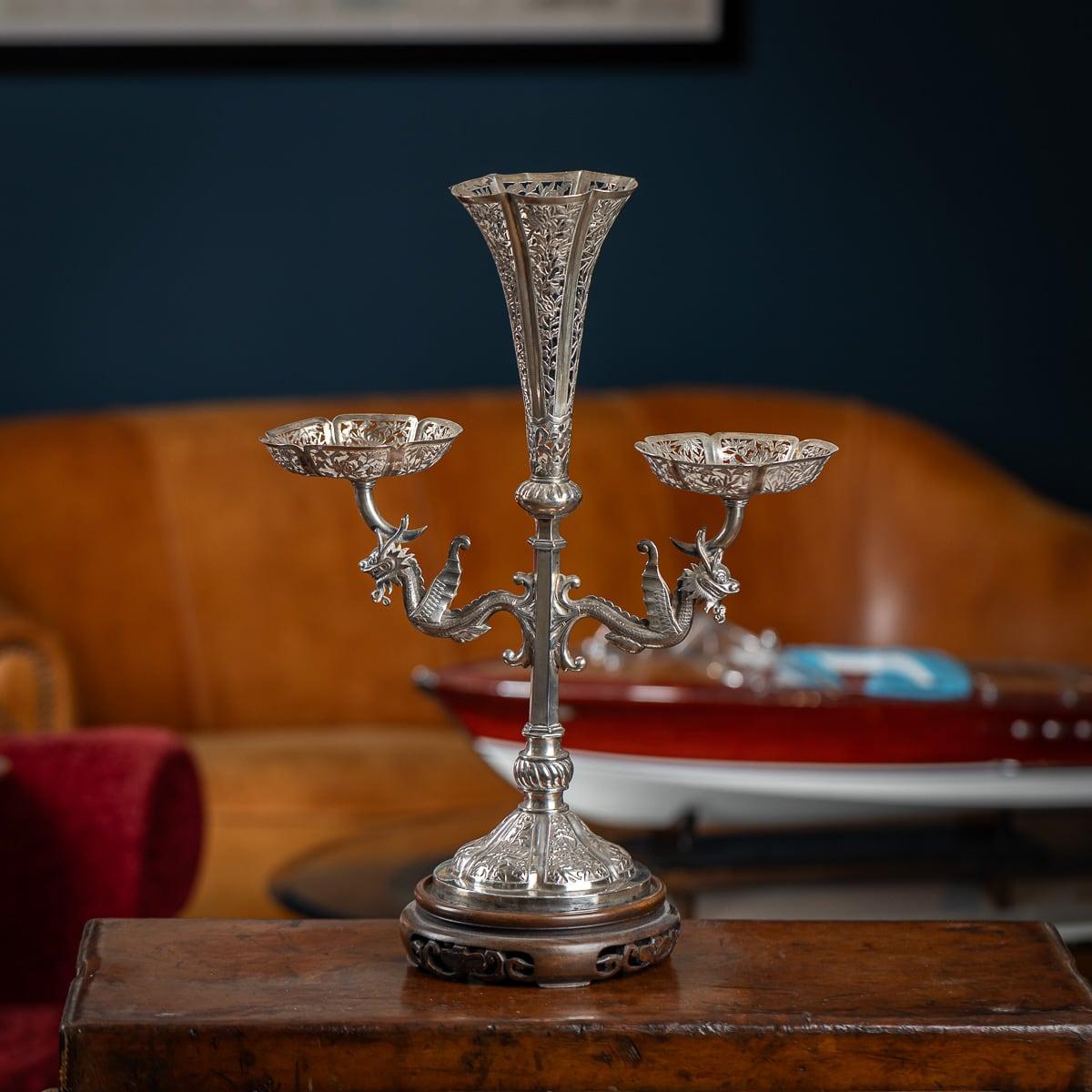 Antique late-19th century Chinese very unusual solid silver eperne, the central trumpet shaped vase and twin baskets are highly decorated with pierced bamboo leaves, cherry blossom and chrysanthemums flowers. The stem applied with finely modelled