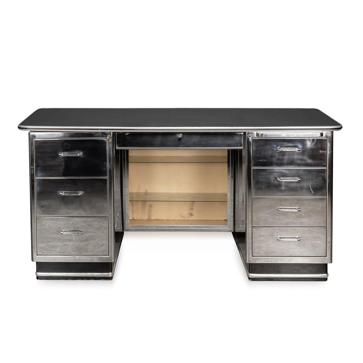 Unusual mid-20th Century polished metal doctors desk with eight lockable drawers of various sizes and a retractable instrument tray. The desk top with the original black formica edged with polished metal. Made and designed by Baisch, a German