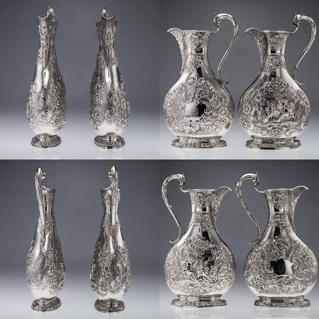 Antique 19th Century pair of early-Victorian extremely large and magnificent Solid Silver flagons / beer jugs, each baluster body of unusual squashed form, embossed in very high-relief with flowers, leaves and scrolls, the other side depicting a