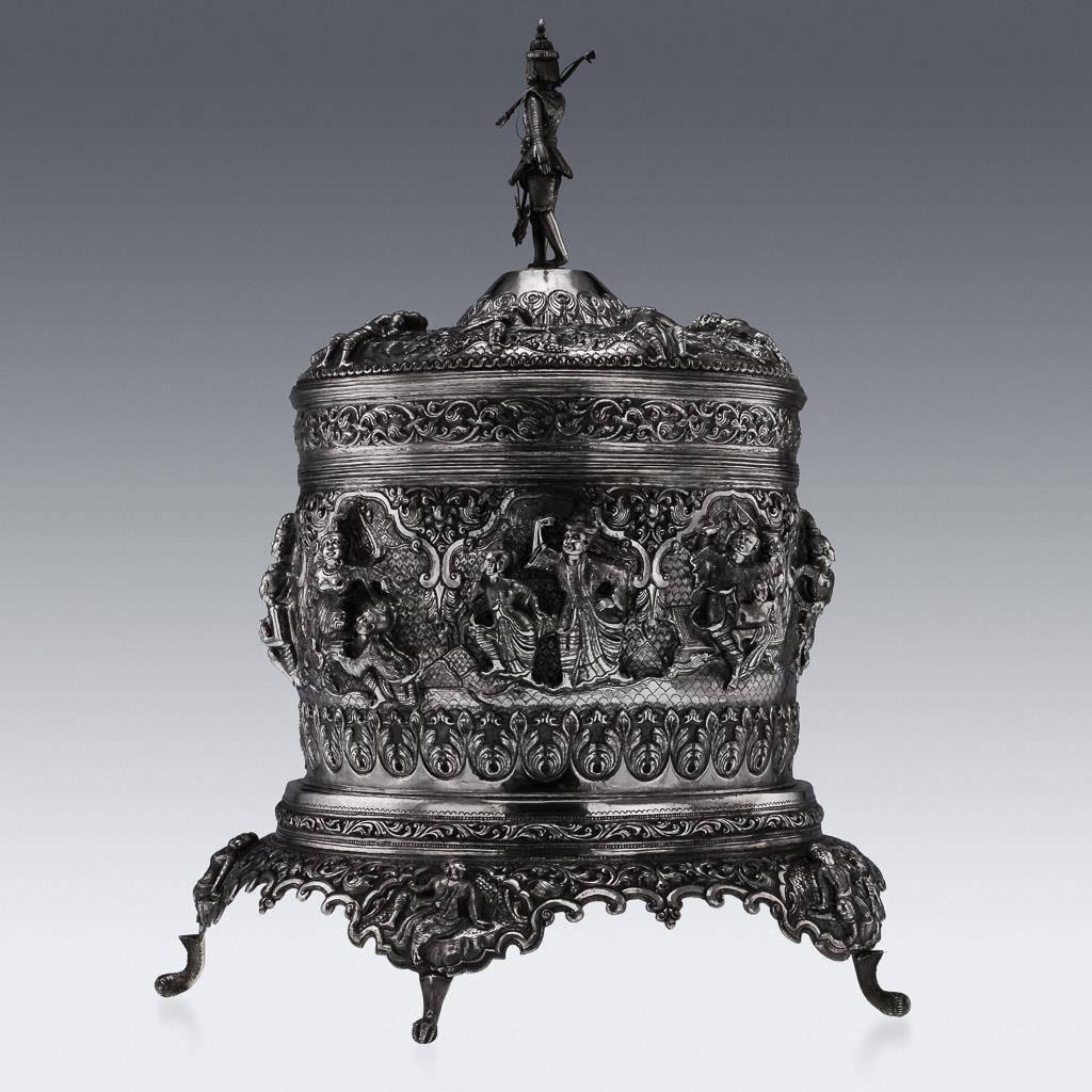 Antique 20th Century Burmese Colonial solid silver betel box and stand, massive size (48 cm tall) and heavy (4.5 kg), higly-decorative, each part is chased in very high-relief with various scenes from Burmese floklore, surrounded by scrolling