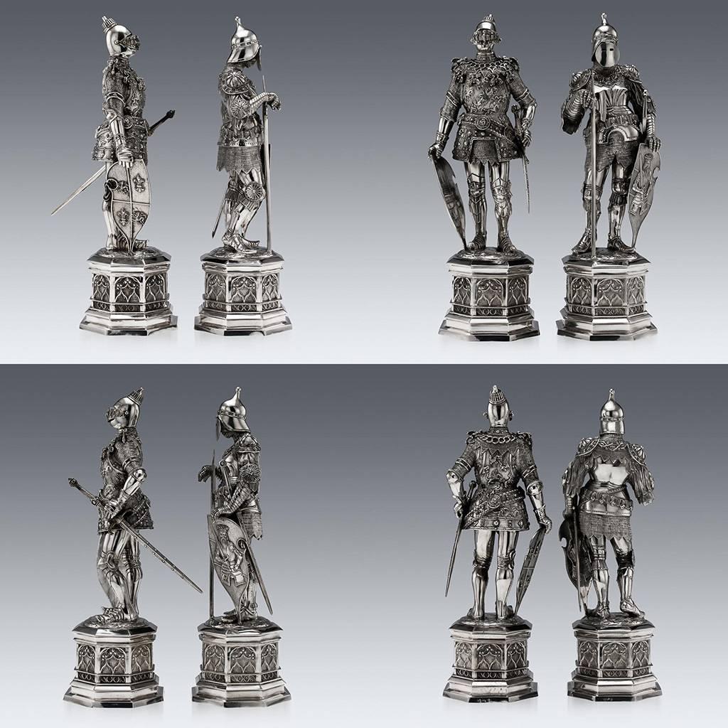 Antique early-20th Century pair of exceptionally large and fine German solid silver figures, each modelled as a knight in full suits of armour, carved face beneath a hinged visor, one sporting a sword and the other an axe, both holding a shield