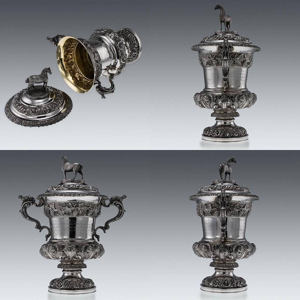 Antique 19th Century unique and exceptional Indian Colonial solid silver presentation trophy cup and cover, the massive campana-shaped body on a circular stepped foot chased with flowers and scrolling foliage, the body chased with a band of trailing