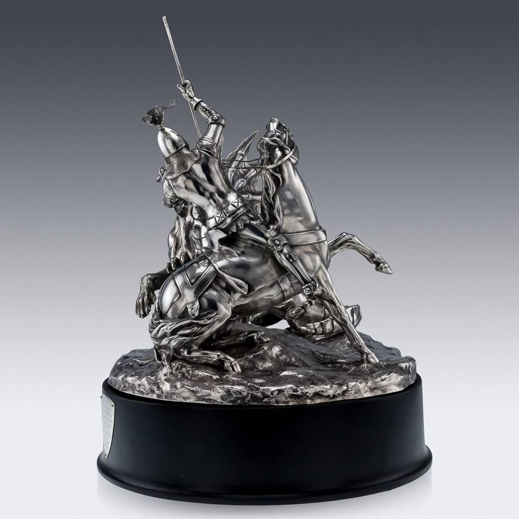 Antique 20th Century exceptionally rare and magnificent Edwardian Solid Silver monumental centrepiece on a stand, formed as Saint George horseback slaughtering the dragon, on a rocky circular base. This is one of the most impressive and outstanding