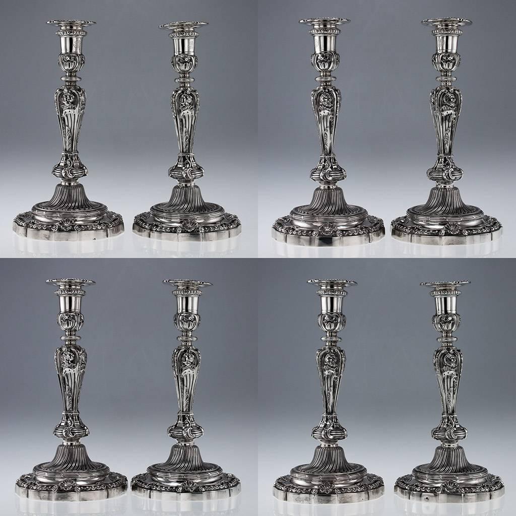 Antique 19th Century rare pair of French Solid Silver candlesticks, exceptionally large and heavy, each shaped-circular base spirally fluted and embellished with shells and beads, the columns cast depicting male and female busts in profile, the