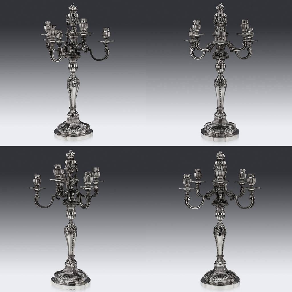 Antique early-20th Century pair of magnificent and exceptional French seven-light candelabra, very large and exceptionally heavy (9590 grams of high-grade solid silver), cast in the Louis XVI style, shaped-scircular reeded bases with acanthus