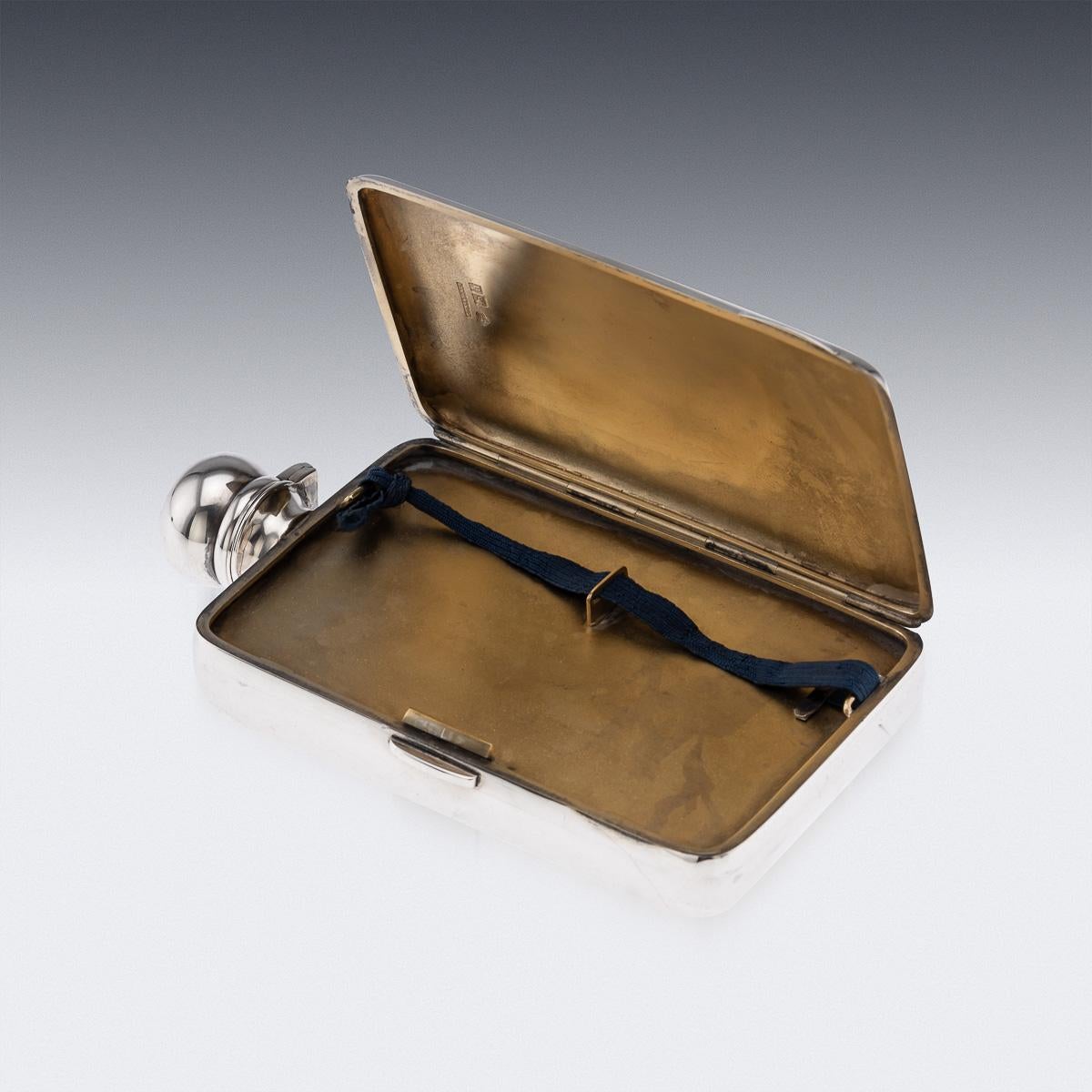 Antique early 20th Century English solid silver hip flask with a hinged top and built in cigarette case on the side. Inside the case, it is richly gilt and can store small cigarillos or cigarettes. Hallmarked English silver (925 standard), London,