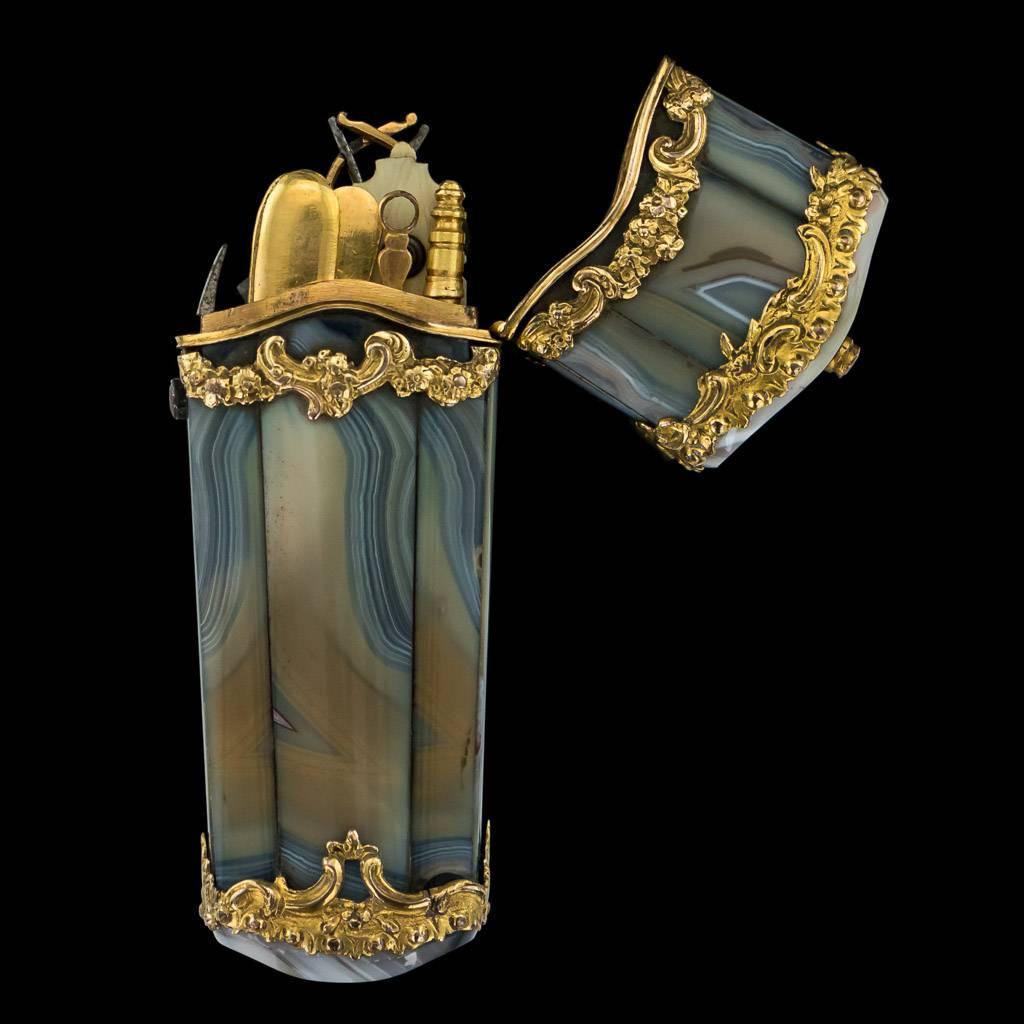 Description

Antique mid-18th Century Georgian 18-karat gold mounted on agate etui, of quiver form, the openwork gold mounts chased with scrolls and flowers, banded grey agate panels, enclosing contemporary and later gold and steel implements: fan