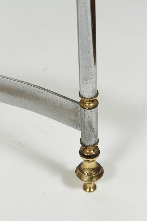 Brass and chrome coffee table with stretcher base in the style of Maison Jensen.