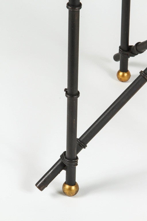 Black metal faux bamboo side table with brass caps and glass top