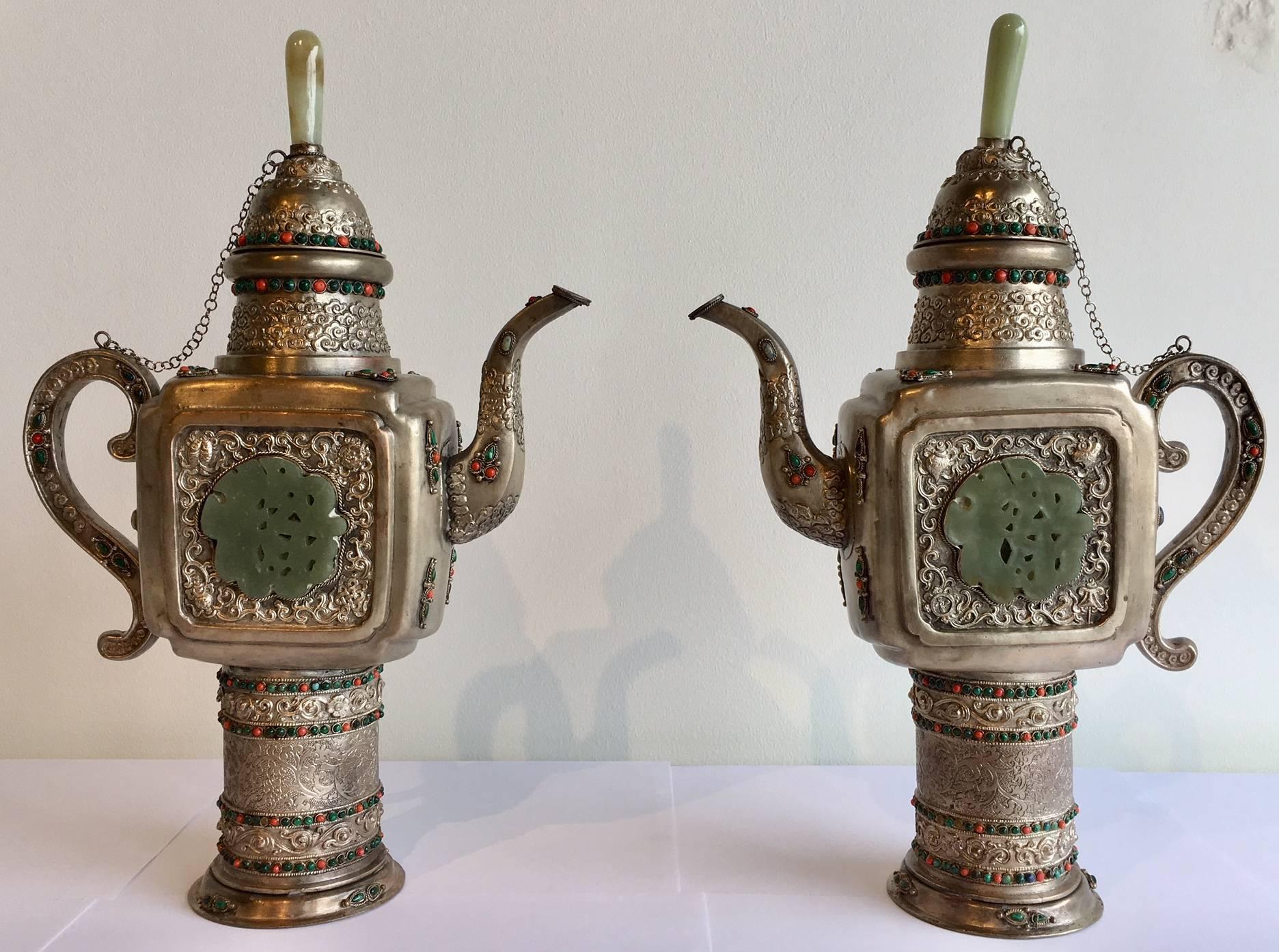 This teapot is made of silver overlaid on pewter, and adorned in semi-precious stones. 
It is inlaid with turquoise, coral, blue lapis, and green jade. It's Mongolian in style, and features an inlaid central design made of jade. 
Made in the late