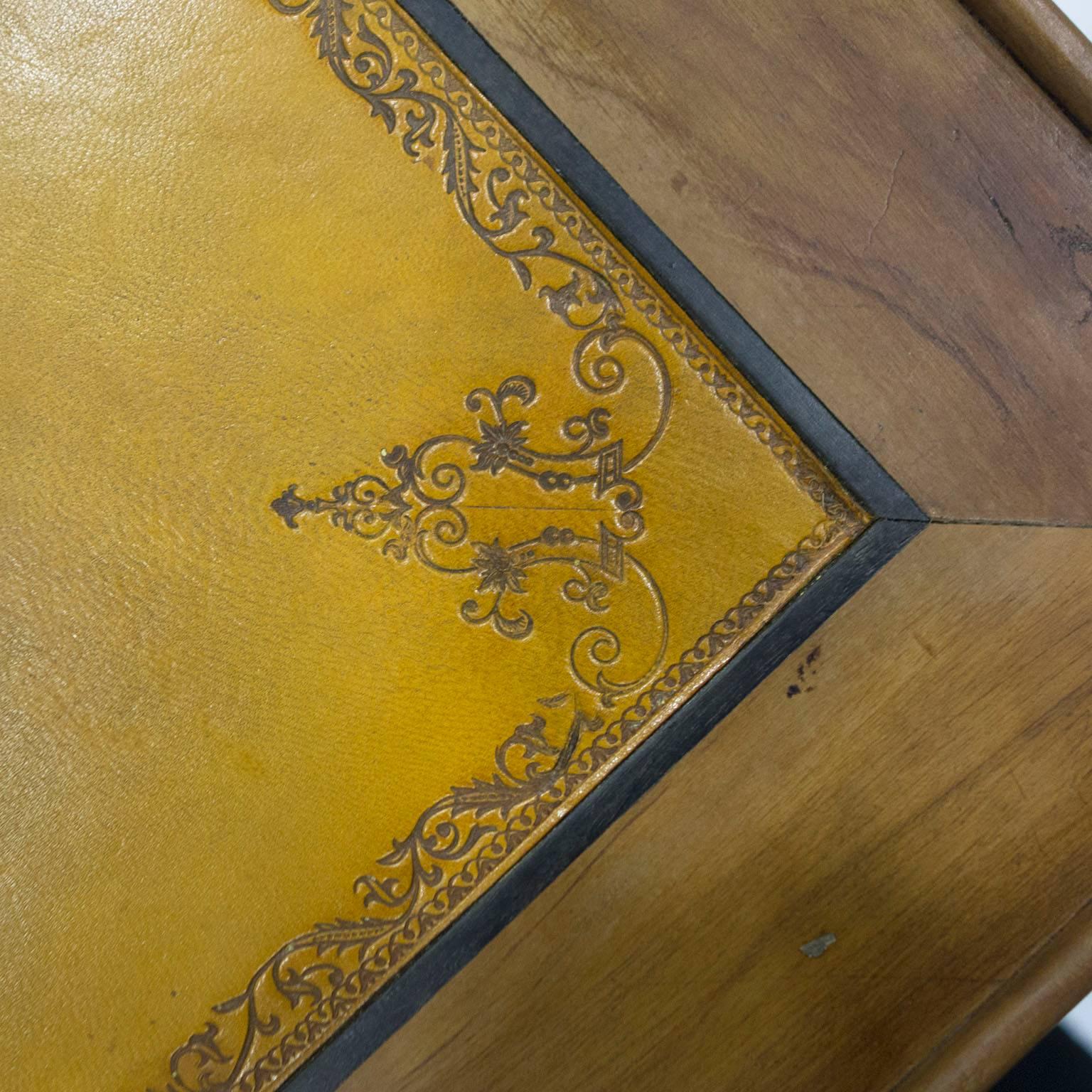 Early 19th century French Provincial game table with tooled leather top, four drawers and hoof feet.