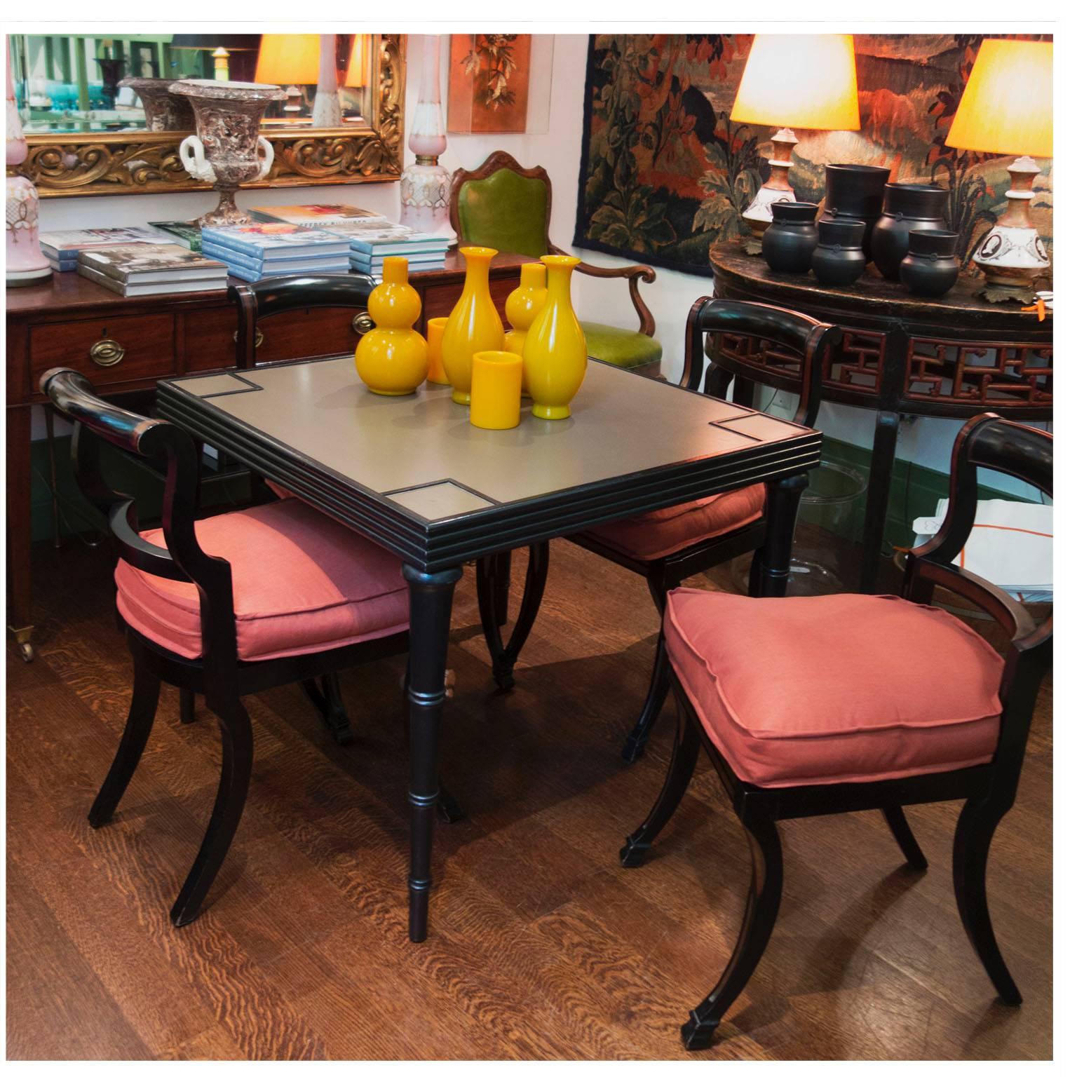 Vintage painted game table with ribbed apron and turned tapered legs in an exaggerated faux bamboo style.