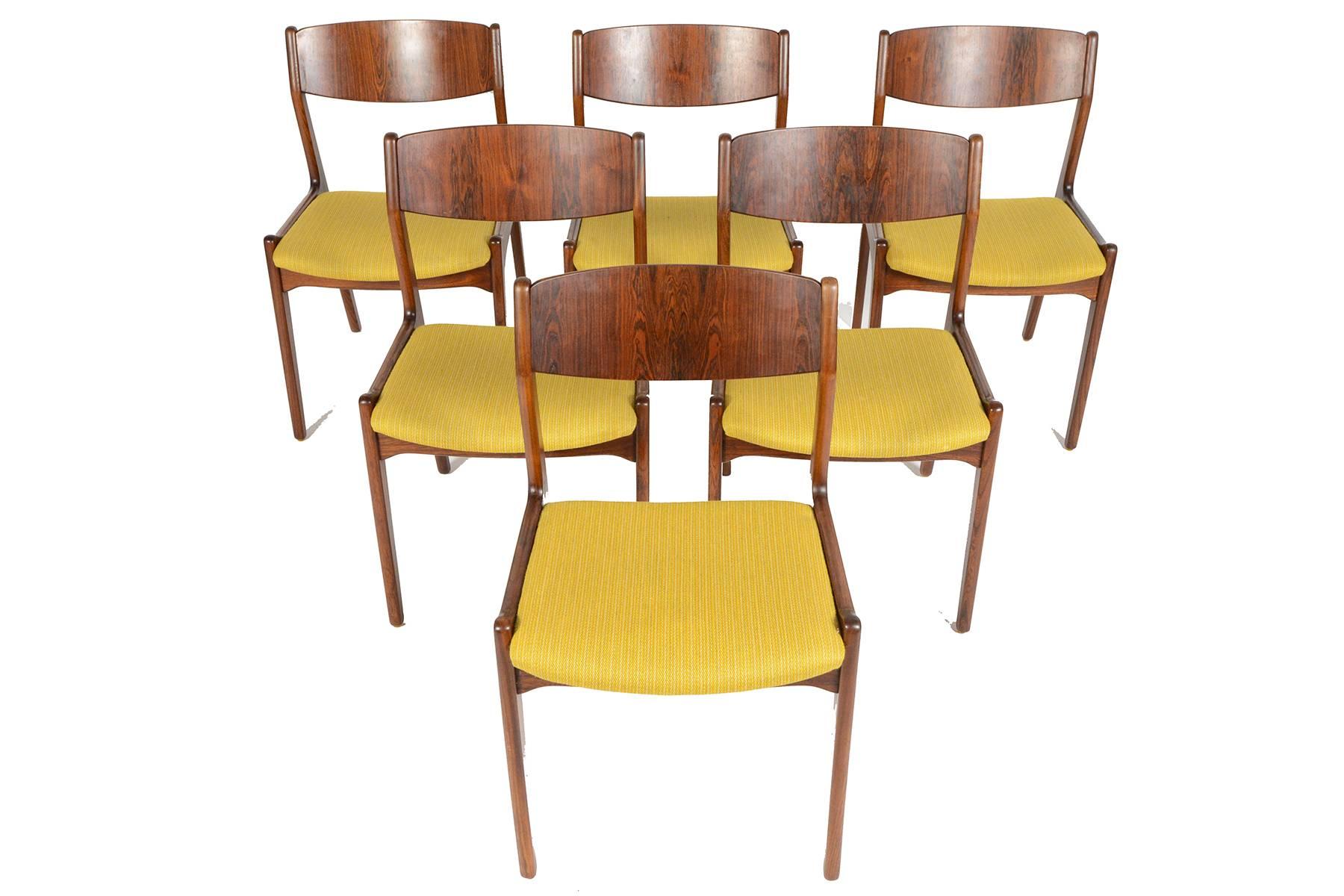 This set of six Danish modern dining chairs were manufactured by Søro Stolefabrik in the 1960s. Crafted in rosewood and stained oak, this set provides comfortable seating for both casual and formal occasions. Frames feature horned seat bottoms and