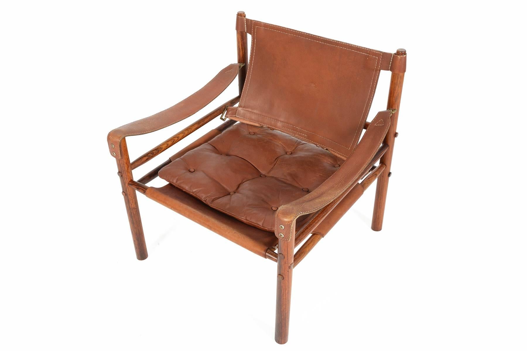 This gorgeous mid century Sirocco chair was designed by Arne Norell in 1964.  The exposed Brazilian rosewood frame is constructed without any glue or screws and uses the support of slung leather. The beautiful original chocolate leather is perfectly