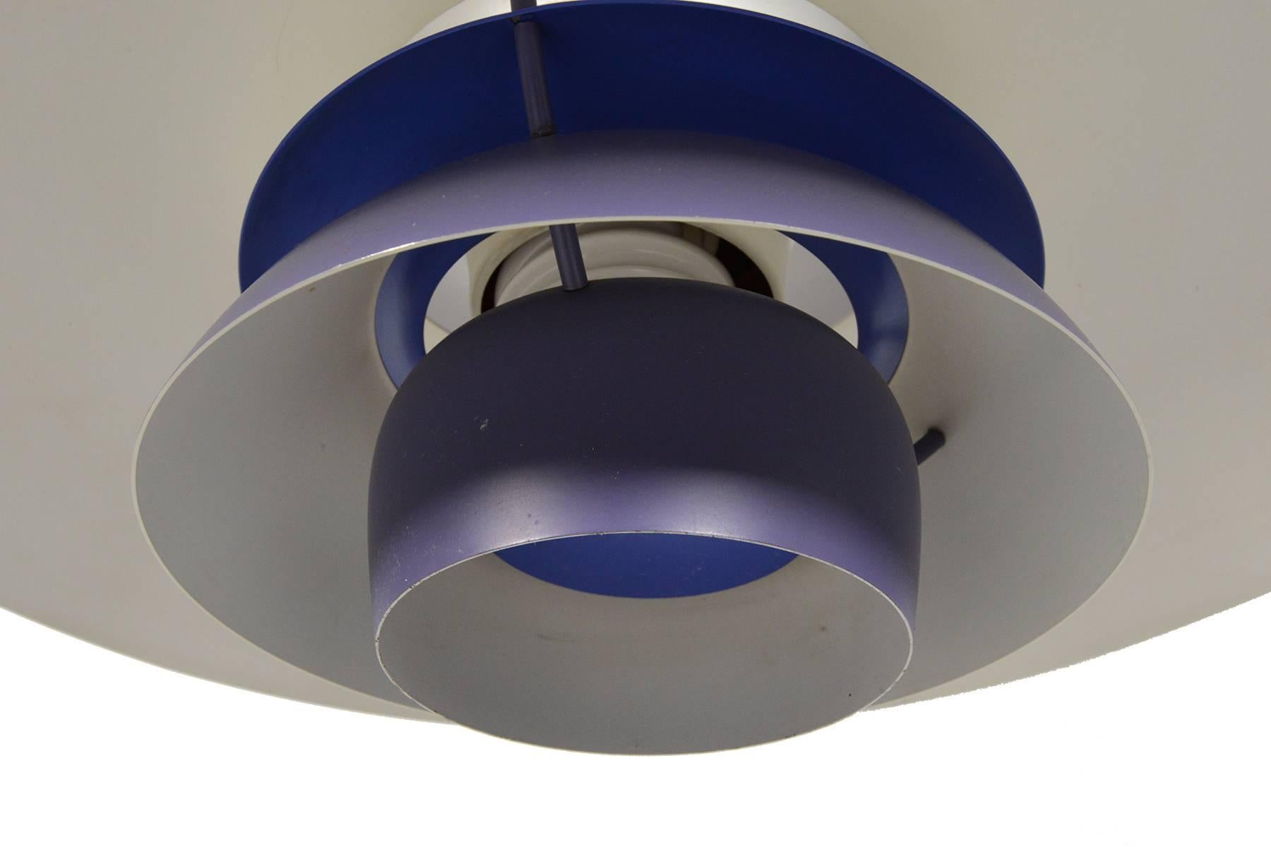 Designed in 1958 by Poul Henningsen for Louis Poulsen, this revolutionary lamp was designed with the home in mind. The purple and white banding diffuses light for a soft, warm tone. In excellent original condition with typical wear for its