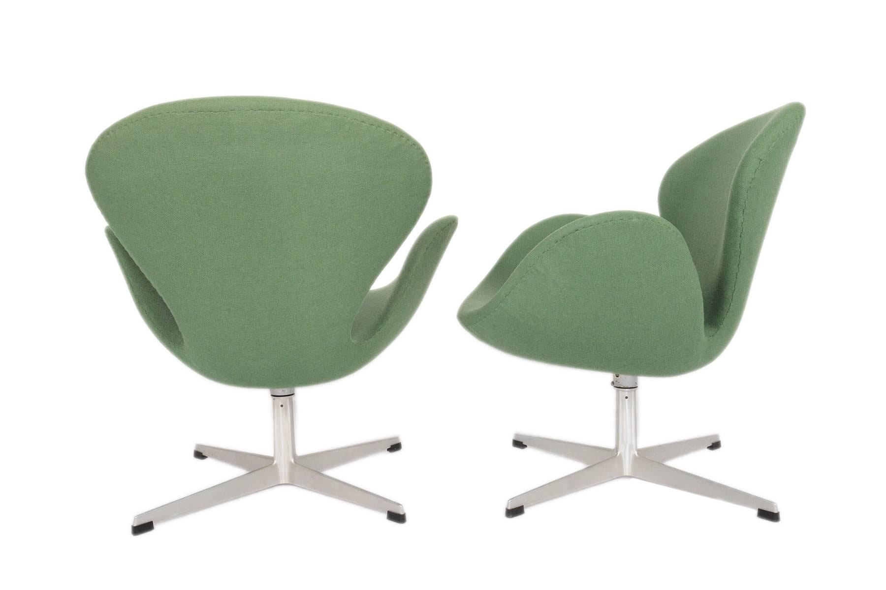 This stunning pair of Danish modern swan chairs was designed by Arne Jacobsen for Fritz Hansen in the late 1950s. Originally conceptualized for the SAS Royal Copenhagen Hotel, these chairs are quintessential icons of Scandinavian design. The chair