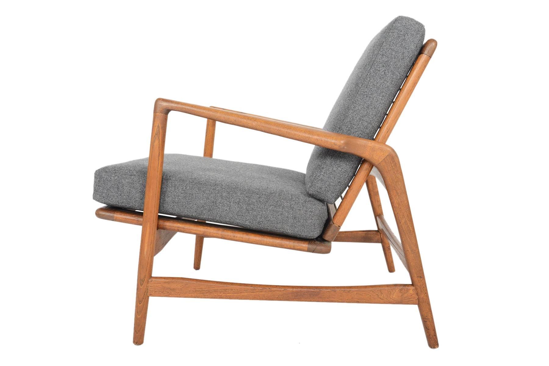 This Danish Modern lounge chair designed by Ib Kofod Larsen for Selig offers the clean lines of a truly timeless design. The gorgeous quarter-sawn oak frame and seamless joinery sets this chair apart. Recently upholstered in grey 